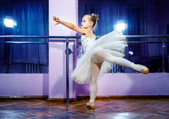 Graceful Elegance in Motion. A young ballerina in a white leotard and tutu