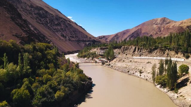 A Confluence of the Indus and Zanskar Rivers. Aerial view of beautiful river and mountain. Tourist attractions in Leh, Ladakh, India. Ladakh's beautiful mountain landscape under blue sky 4k
