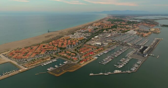 Aerial view of port leucate with mediterranean sea in background, sunset France. Port Leucate aerial view leisure boats marina vacation seaside resort France sunny day