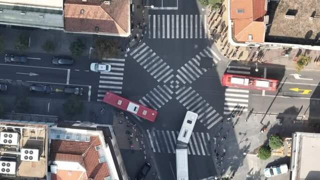 Top view over a crowd pedestrian crossing road intersection, Belgrade. Aerial view od traffic at busy scramble crosswalk