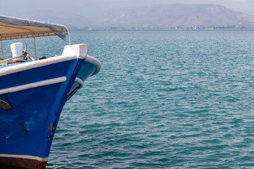 Blue boat on a blue sea