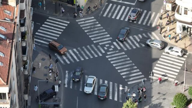 Time Lapse over a crowd pedestrian crossing intersection, Belgrade. Aerial view od traffic at busy scramble crosswalk