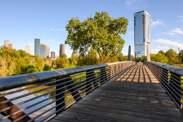 The Rosemont pedestrian Bridge crossing over Buffalo Bayou with a view of downtown Houston skyscrapers. Texas, USA