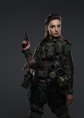 Female warrior dressed as a rebel or partisan in military garb, armed with a pistol, set against a neutral background, representing turmoil in the Middle East