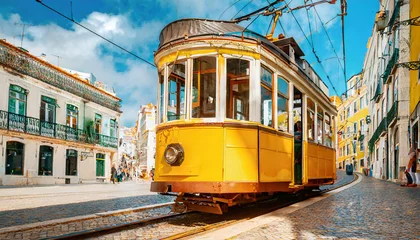 Deurstickers Yellow vintage tram on the street in Lisbon, Portugal. Famous travel destination © Beste stock