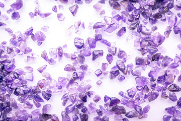 amethyst stone chips macro detail texture background. close-up polished semi-precious gemstone.
