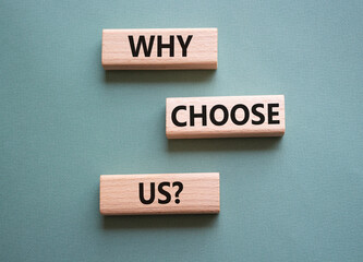 Why choose us symbol. Concept words Why choose us on wooden blocks. Beautiful grey green...