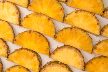 Pineapple juicy yellow slices on a white background.
