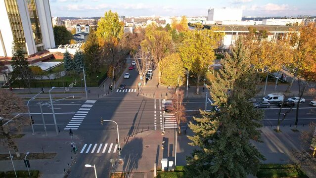 Panoramic aerial drone view of presidency building with flag on top of Republic of Moldova at autumn season. Multiple office, residential buildings, cars riding on background. Chisinau, Moldova. 4K