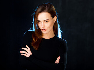 A woman with her arms crossed posing for a picture. A Confident Woman Striking a Pose for a...