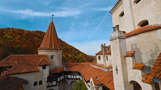 Bright tiled rooftops of the castle Bran in Brasov, Transylvania, Romania. Beautiful view of medieval building in autumn.