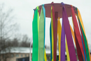 Folk Spring Festival. Colored ribbons on hoop. Totem object. Pagan rite.
