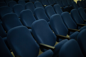 Blue seats in hall. Rows of seats. Cinema Details.
