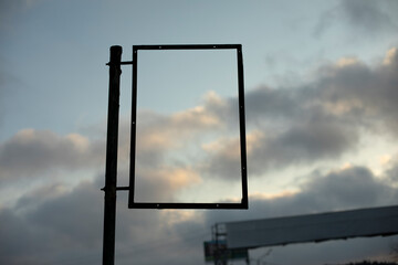Empty frame against sky. Rectangle black. Picture insertion frame.