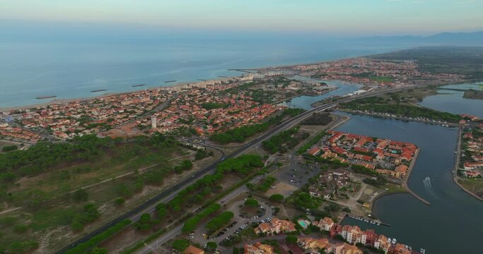Aerial view over port Leucate mediterranean sea sandy shore sunset marina harbor. 