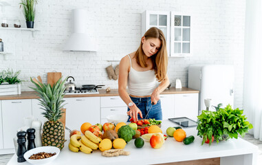 A Woman Enjoying a Bountiful Harvest of Fresh, Colorful Produce. A woman standing in front of a table filled with fruits and vegetables