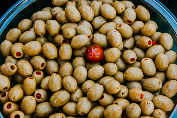 The olive Olea europaea is the fruit of the olive tree. Green olives on market.