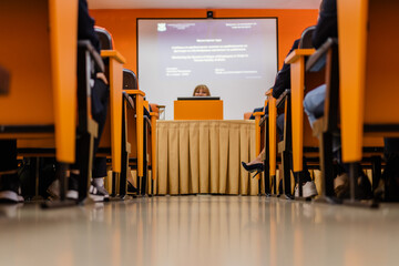 Worm's eye view of a professor giving a lecture in a small classroom