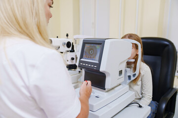 teen girl in ophthalmologist's office. computed tomography of the eye