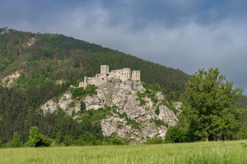 Fototapeta na wymiar Ruins of medieval castle Strecno on the rock, Slovakia, Mala Fatra, spring day, blue sky with clouds.