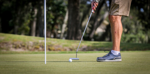 Man putting ball to the hole on a golf course in Central Florida
