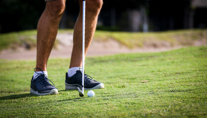 Lining up for golf chip shot on the fringe of golf course around golf green in Central Florida