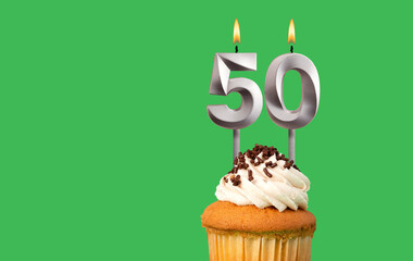 Birthday card with candle number 50 - Cupcake on green background