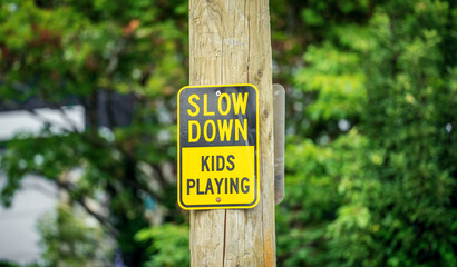 Slow down. Kids playing traffic sign