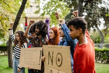 People strike against war and racism, portrait group of multiracial young people with banners,...