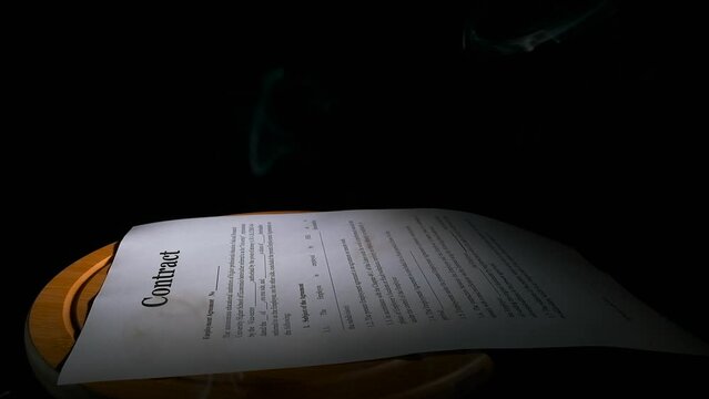 Lose business contract indoor. A view of business papers lay on the table against black background. A concept of unfortunate documents on the black background.