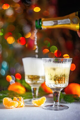 Tangerines and champagne on a Christmas background. Selective focus.