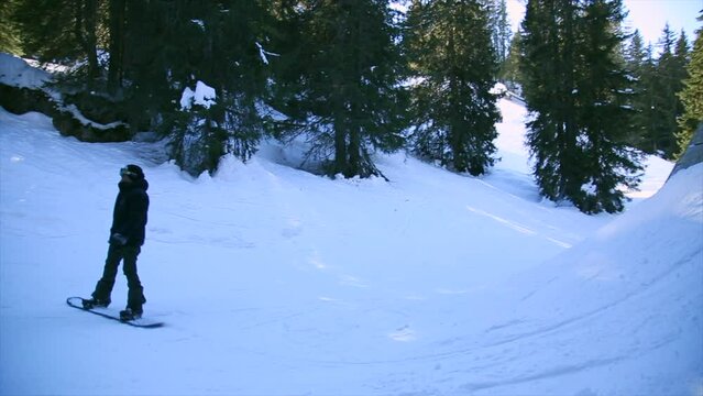 Freestyle snowboarder making a trick in Avoriaz snowpark