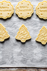 Top view of cut out raw sugar cookie dough for christmas, Christmas sugar cookie dough about to be baked, process of making xmas sugar cookies