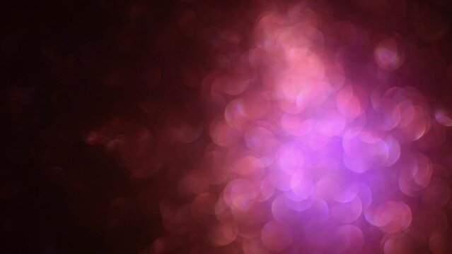 Abstract dark red sparkly soft out of focus background flowing bright shiny centre moving constantly left to right  