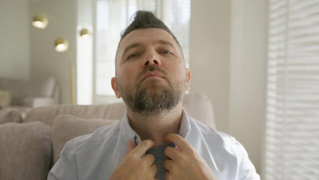 Handsome male model bearded guy checking modern faux hawk hairstyle. Front view smiling 40s caucasian man fix hairstyle, enjoy fringe up look reflection. Mature smiling guy.Barbershop grooming concept