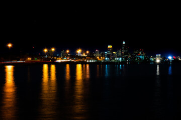 Fototapeta premium Streetlamps Reflecting in Lake Erie with Cleveland in the Distance