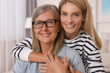 Happy mature mother and her daughter at home