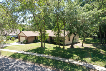 Aerial view of suburban ranch house among trees, Daytona Beach, Florida.