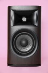 One wooden sound speaker on pink background