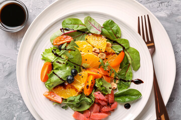 Delicious salad with salmon served on gray textured table, flat lay