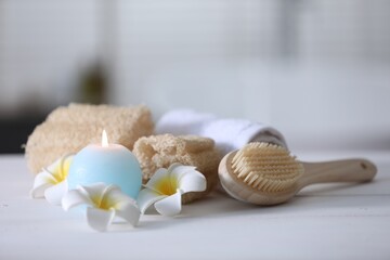 Composition with different spa supplies and flowers on white table indoors, closeup. Space for text