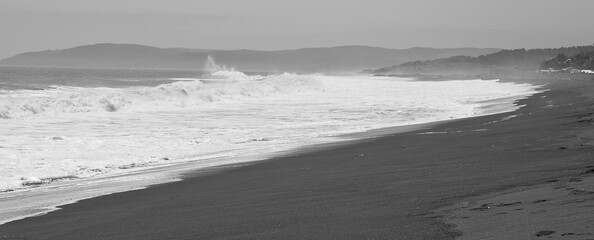 Waves on blsck sand beach during windy day (Constitucion, Maule, Chile)