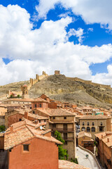 Fototapeta na wymiar View over rooftops and the historic wall on the hill in Albarracin, Spain