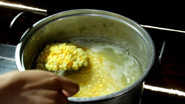 Stirring the corn soup in the container