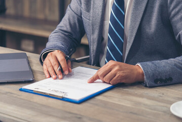 Close up manager businessman hands sign contract working meeting. Asian business man using pen signing on new contract to starting projects in conference room.  Business agreement concepts.