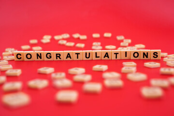 The word CONGRATULATIONS with wooden letter