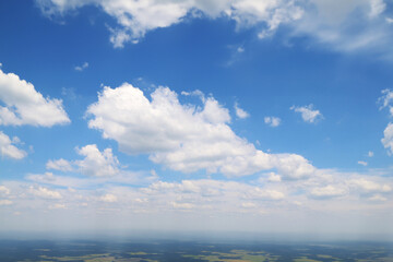 Naklejka na ściany i meble blue sky horizon air land flying flat rural white clouds aerial cloudy day