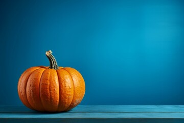 Vibrant pumpkin on table against blue background. Generative AI