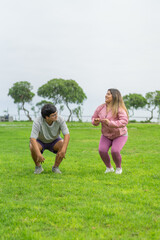 Obraz premium Two fat people in sports clothes jumping on a park