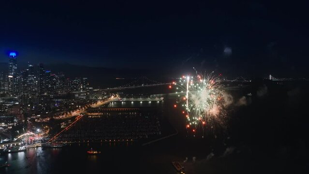 Aerial concept of 4th of July, Independence day background, USA. Beautiful colorful fireworks above San Francisco bay. Celebration in modern city at night for abstract New Year celebration background